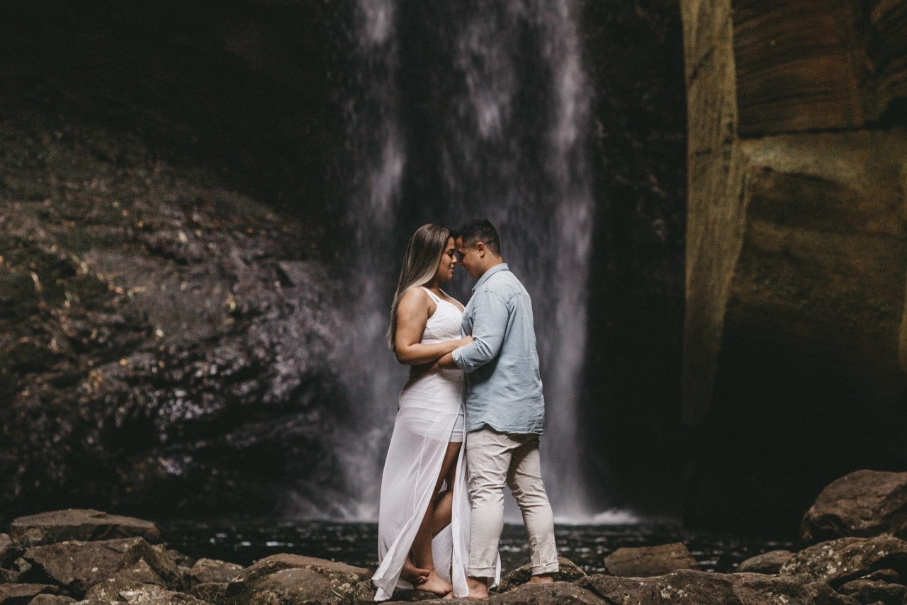 a couple embracing under a waterfall