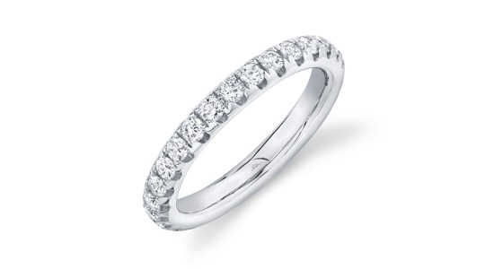 a silver eternity wedding band featuring round cut diamonds