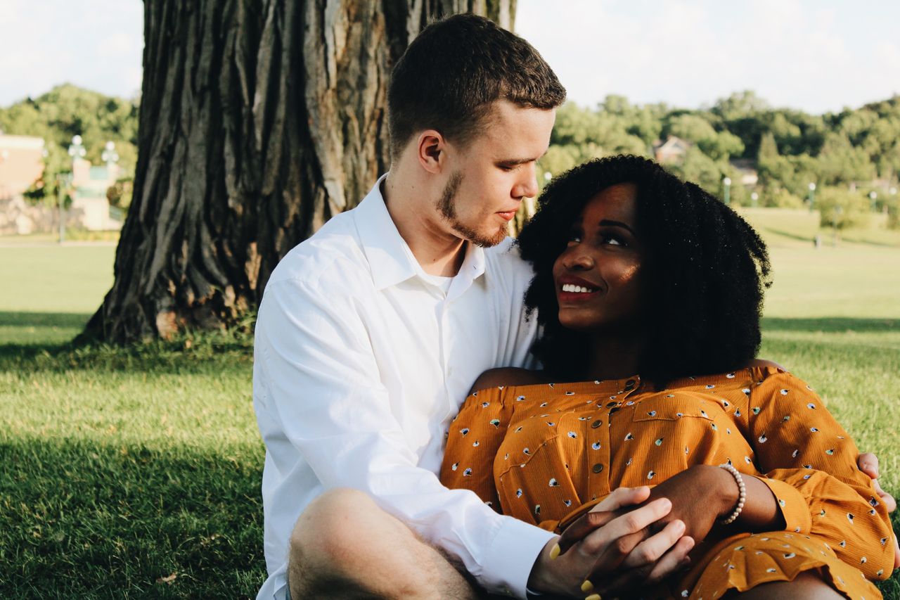 Couple holding hands in a park.