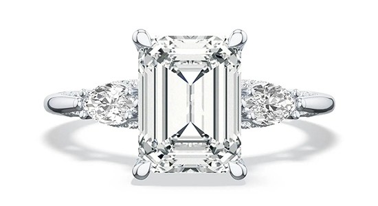 a white gold, three stone engagement ring with an emerald cut center stone, available at Gerald Peters.