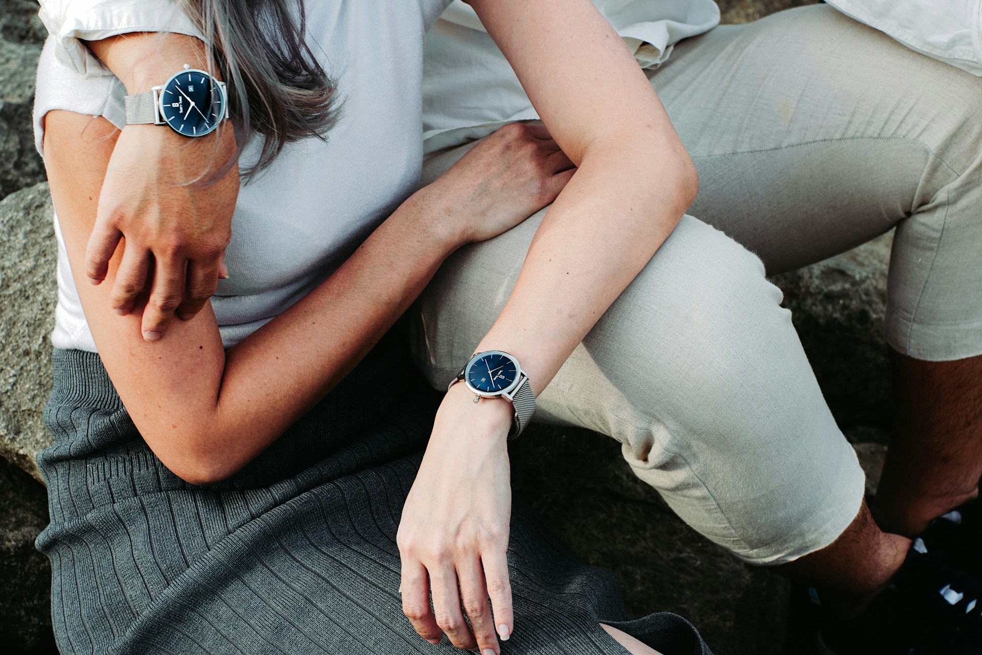 a couple embracing and wearing dress watches