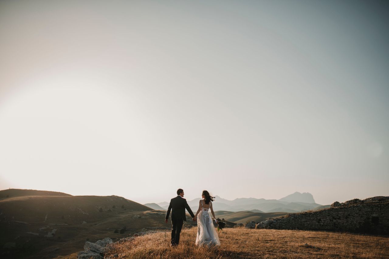 Happy newly married couple on the hill